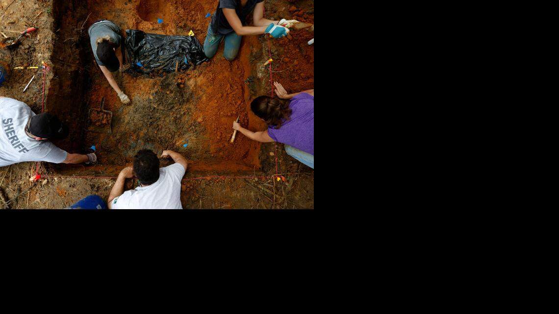 
UNMARKED DOZIER GRAVES: After unearthing skull fragments, anthropologists carefully search for more remains.


