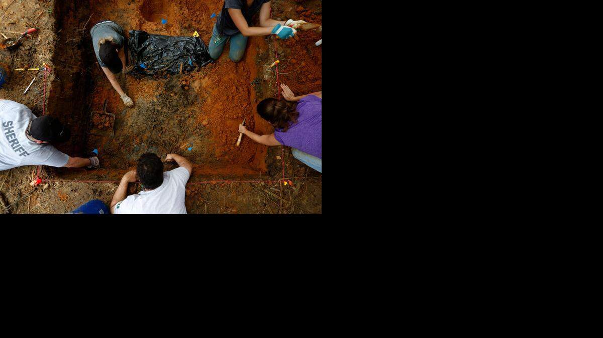 
UNMARKED DOZIER GRAVES: After unearthing skull fragments, anthropologists carefully search for more remains.


