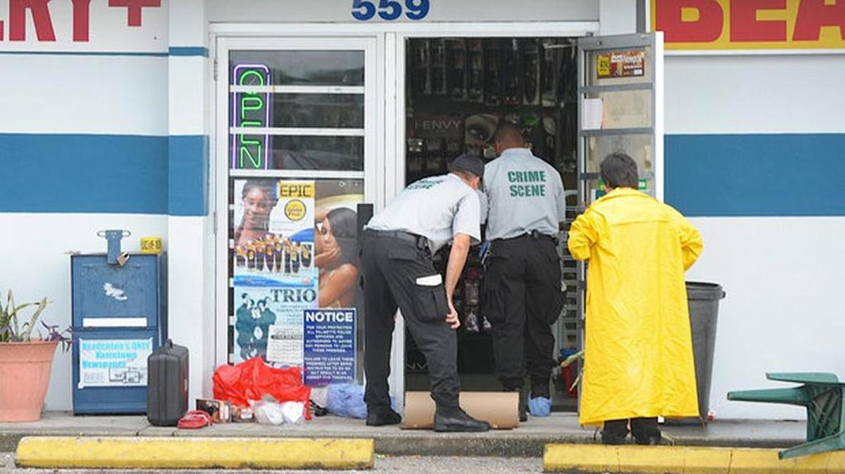 
After arriving with equipment, crime scene technicians examine the scene where two store clerks were shot to death Monday, Sept. 7, at Snappy's Mart on 17th Street West in Palmetto.
