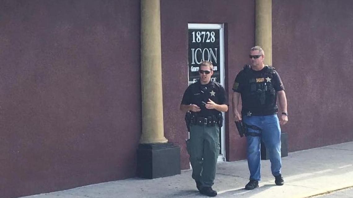 Pasco sheriff’s deputies wait outside Icon, a strip club on U.S. 19 in Hudson, as inspectors inside check Tuesday to see if the club is complying with rules designed to battle human trafficking.