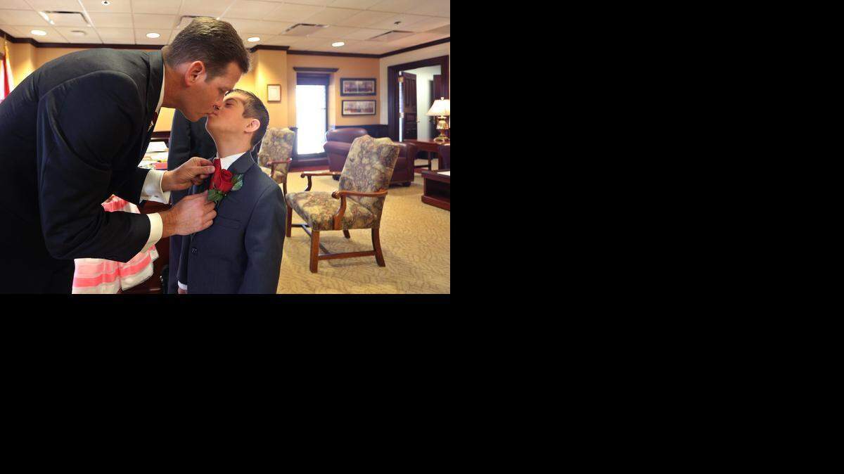 
FATHER AND SON: Florida Senate President Andy Gardiner, R- Orlando, gives his son Andrew Jr., 11, a kiss in his office, March 3, 2015, prior to the start of the annual Florida Legislative session in Tallahassee.
