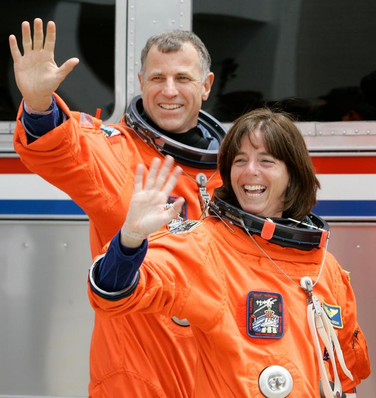 Members of the STS-118 crew mission specialist Barbara Morgan, front, and Canadian Space Agency astronaut Dave Williams, rear, wave as they leave the Operations and Checkout Building with their colleagues on their way to Launch Pad 39A and Space Shuttle Endeavour Wednesday, Aug. 8, 2007, at the Kennedy Space Center at Cape Canaveral, Fla.