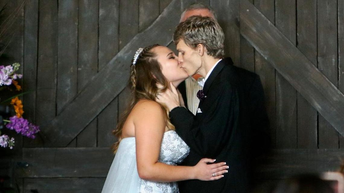 In this Sunday, Jan. 28, 2018, file photo, Dustin Snyder, 19, kisses his wife, Sierra Siverio, after exchanging wedding vows at The Big Red Barn in Plant City, Florida. Snyder, who had been battling a rare form of cancer has died less than a month after marrying his high school sweetheart.