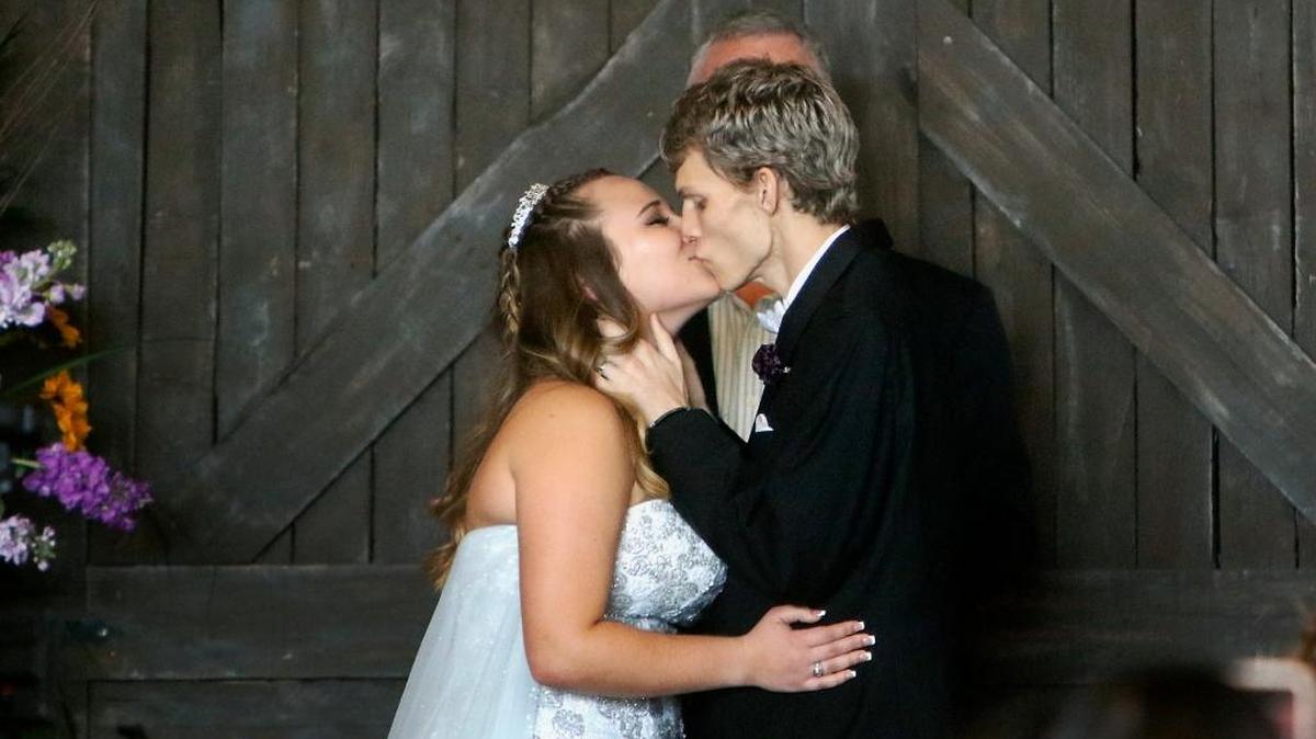 In this Sunday, Jan. 28, 2018, file photo, Dustin Snyder, 19, kisses his wife, Sierra Siverio, after exchanging wedding vows at The Big Red Barn in Plant City, Florida. Snyder, who had been battling a rare form of cancer has died less than a month after marrying his high school sweetheart.