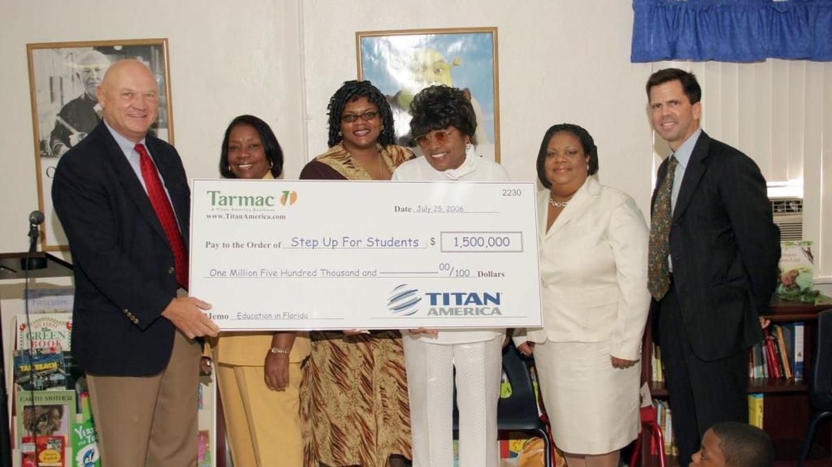 Hardy Johnson, left, Florida president of Tarmac America, presents a check for $1,500,000 to the Step Up for Students scholarship organization in August 2006. Accepting the check are Johnnie Lowery, second from left, chairman of the Board of New Jerusalem Christian Academy; Laura Jones, Step Up for Students scholarship parent and her mother Annie Mae Carter; Pauline Darling, executive administrator of New Jerusalem Christian Academy; and John Kirtley, president of the Florida School Choice Fund and chairman of Florida PRIDE, the organization behind Step Up for Students.