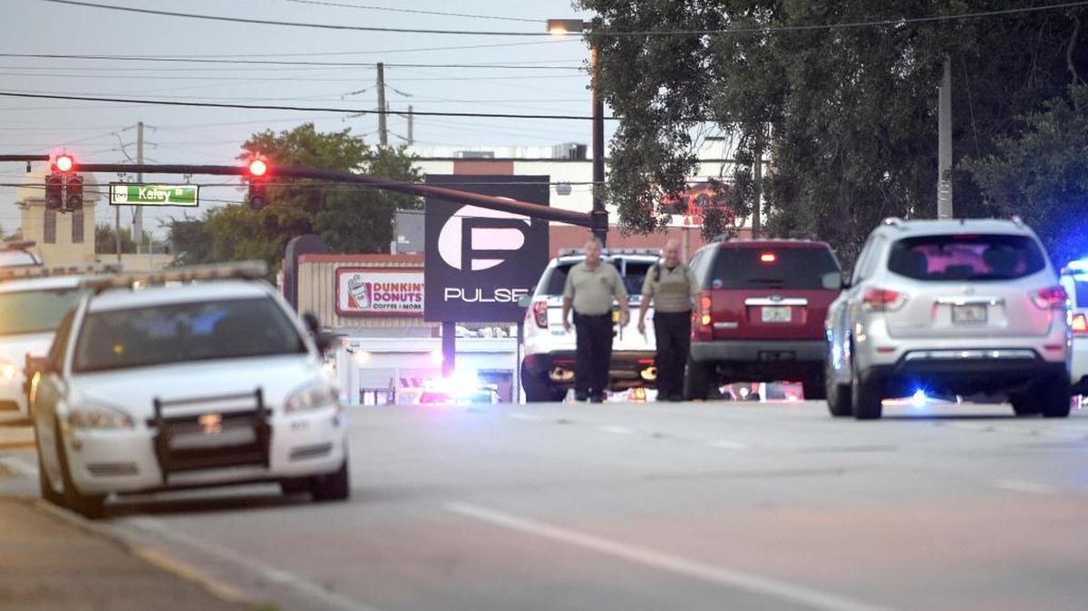 Police cars surround the Pulse Orlando nightclub, the scene of a fatal shooting, in Orlando, Fla., Sunday, June 12, 2016.
