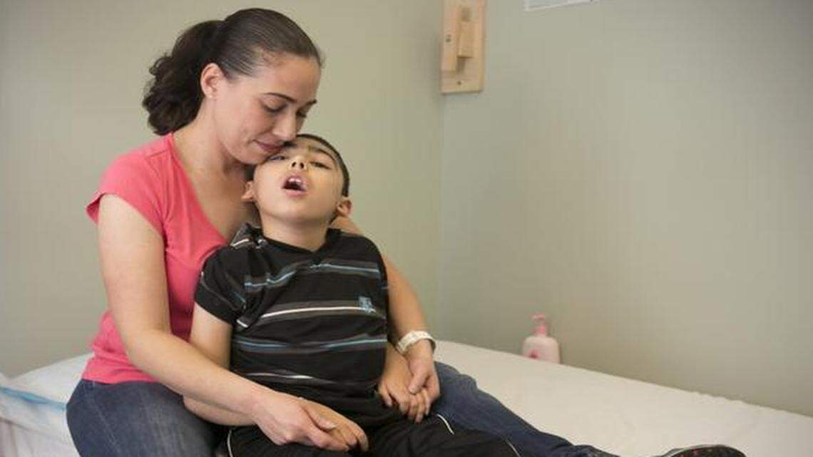 
Nancy Peruyero sits with her son Nicolas, 9, after a physical therapy session. Nicolas has Batten Disease, an inherited disorder of the nervous system that causes seizures.
