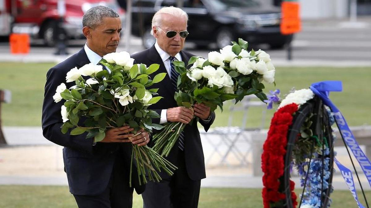 President Barack Obama and Vice President Joe Biden place flowers during their visit to the makeshift memorial at the Dr. Phillips Center for the Performing Arts on June 16, 2016 in downtown Orlando.
