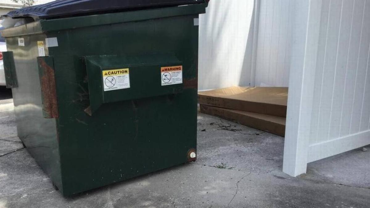 City officials say the landlord who reported a naked woman using his dumpster enclosure as a bathroom brought the problems on himself by not getting a permit for the enclosure and it not being up to “city standards.”