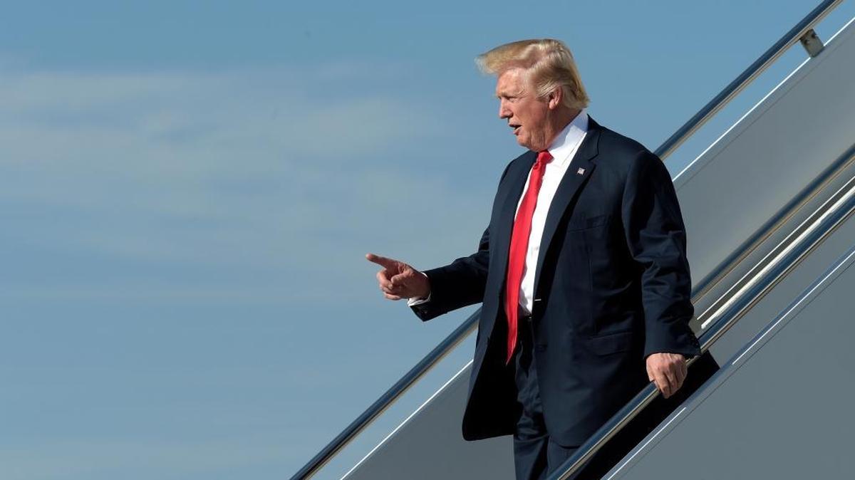 President Donald Trump walks down the steps of Air Force One as he arrives at Palm Beach International Airport for a third consecutive weekend at his Mar-A-Lago estate in February.