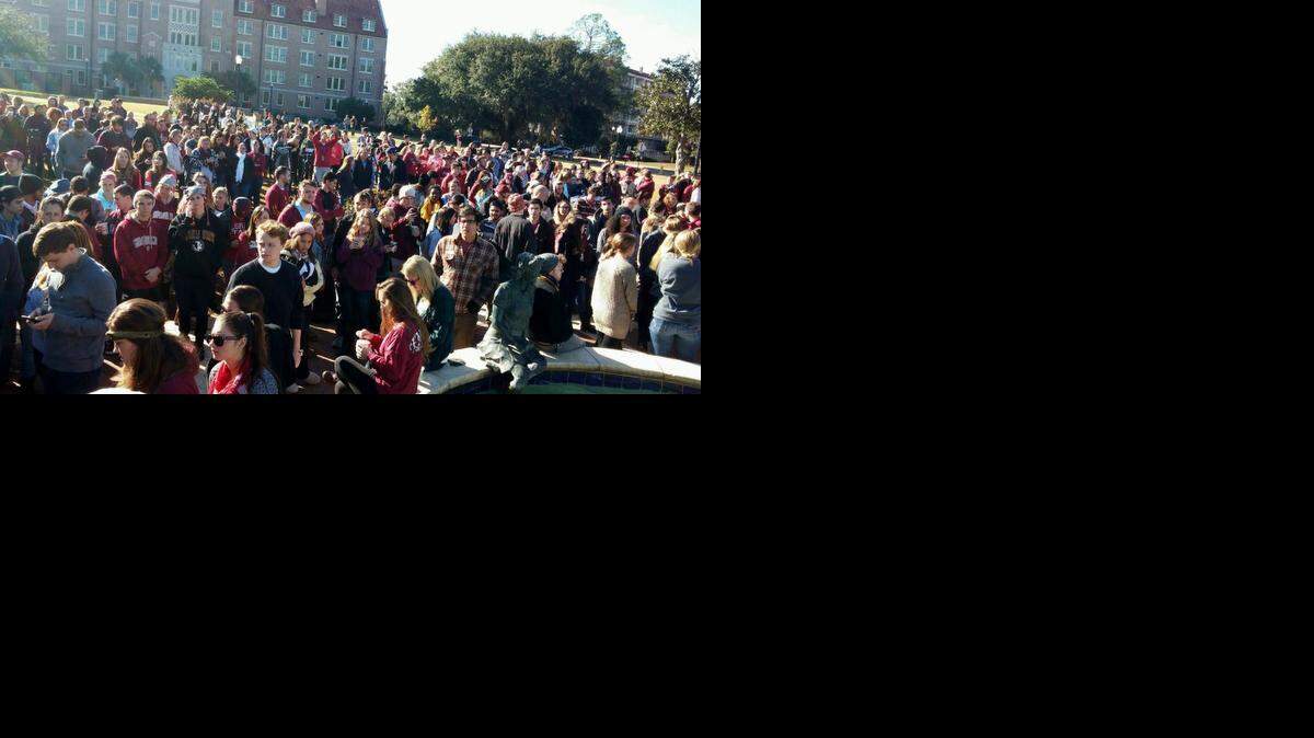 Florida State University students gather at Landis Green for a prayer service on Thursday, Nov. 20, 2014 after an overnight shooting at the campus library in Tallahassee, Fla.