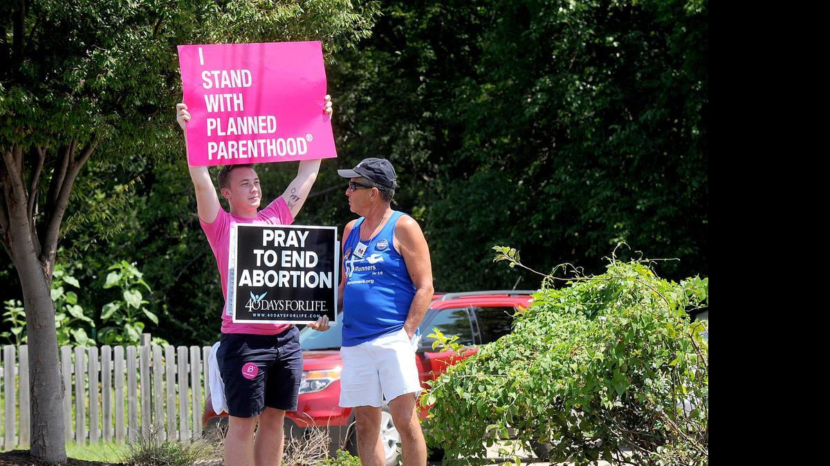 
Andrew Ward, left, and Bill Pauls discuss their positions on abortion Tuesday, July 28, during a rally across the street from the Planned Parenthood of Kansas and Mid-Missouri in Columbia, Mo. 
