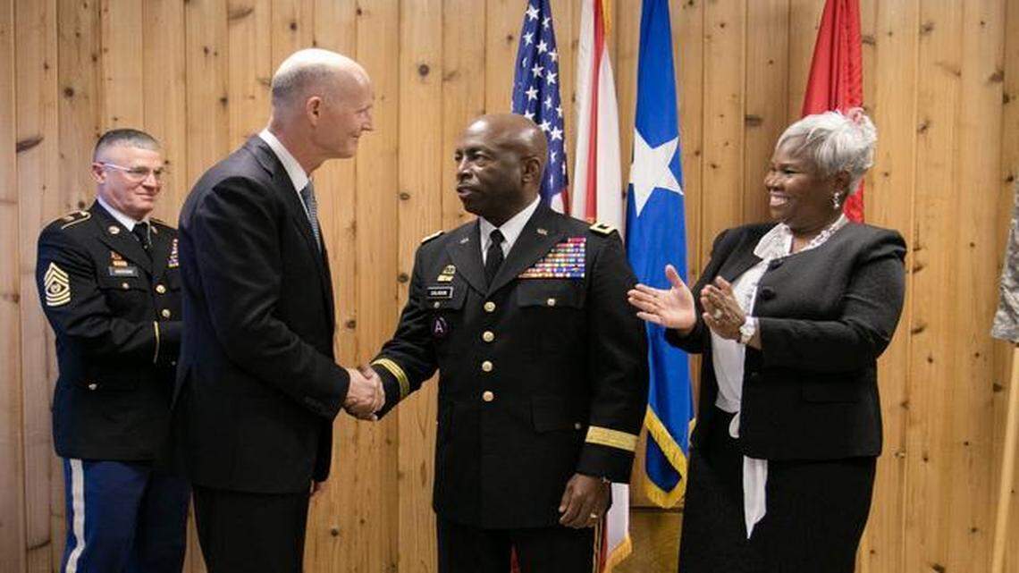 
Army Maj. Gen. Michael Calhoun, his wife Sophia to the right, is congratulated on his promotion by Gov. Rick Scott at the historic St. Francis Barracks on March 6, 2015. State Command Sgt. Maj. Robert Hosford looks on.
