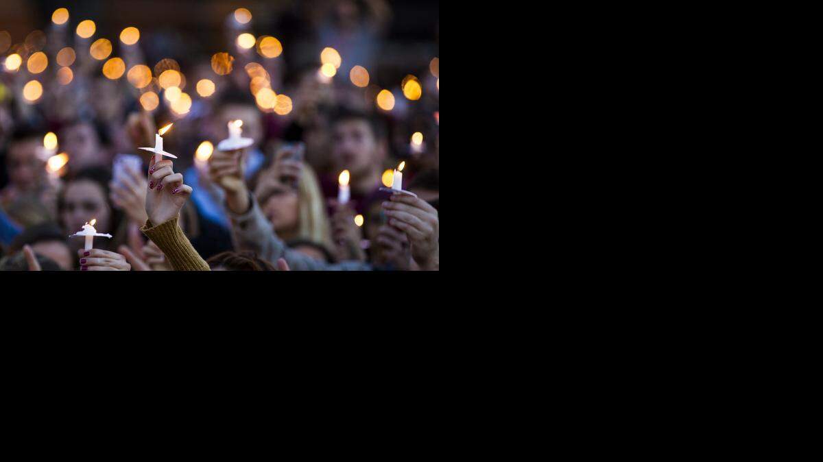 
Florida State University students hold candles during the Gathering of Unity candlelight vigil on campus after the shooting of three FSU students earlier in the day on November 20, 2014 in Tallahassee. 
