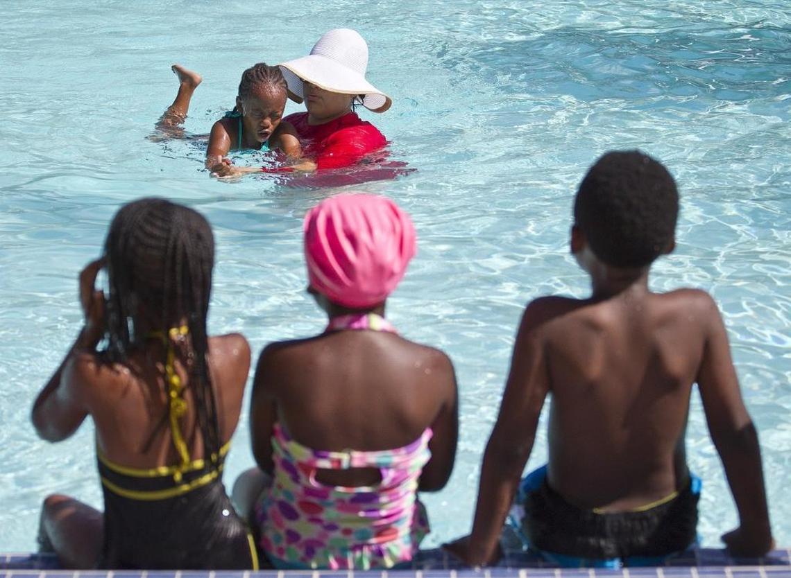 Instructor Leslie Brache teaches Amira Griffiths, then 7, how to swim at Sgt. Joseph Delancy Pool in Richmond Heights in 2015.