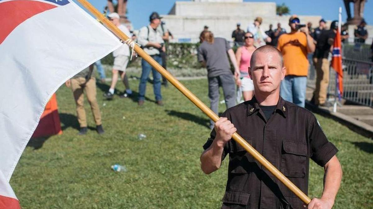 Ken Parker, a self-proclaimed Nazi, stands in front of the Robert E. Lee monument in New Orleans on May 7. He was banned from the University of North Florida's campus after school officials said he posed a risk to student safety.