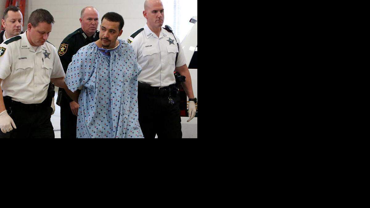 
Marco Antonio Parilla Jr., 23, is escorted into the Pinellas County Jail after being arrested on suspicion of first-degree murder. Tarpon Springs police Officer Charles Kondek was fatally shot while investigating a complaint about a loud car stereo in a neighborhood near Spring Bayou. 
