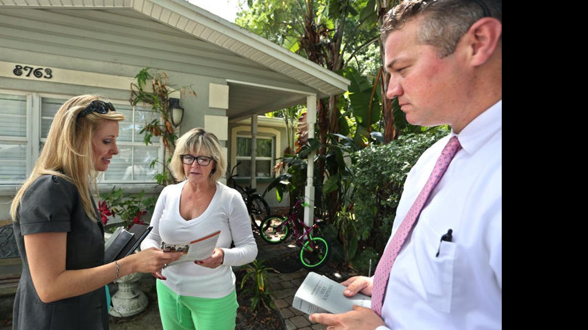 
Jehovah’s Witnesses Mary and Jonathan Burns share Bible verses and literature with Pinellas Park resident Leslie Pevey, center. The Burns have visited Pevey several times over the past six months. 
