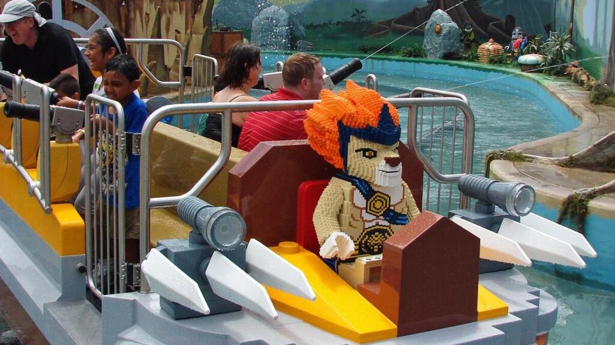 Guests do battle with water cannons on a boat led by Laval the Lion Prince in the new World of Chima attraction at Legoland Florida.