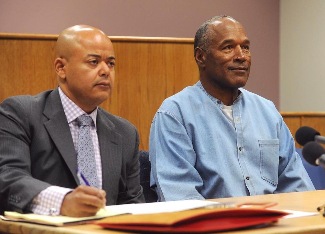 Former NFL football star O.J. Simpson appears with his attorney, Malcolm LaVergne, left, via video for his parole hearing at the Lovelock Correctional Center in Lovelock, Nev., on Thursday, July 20, 2017. Simpson was convicted in 2008 of enlisting some men he barely knew, including two who had guns, to retrieve from two sports collectibles sellers some items that Simpson said were stolen from him a decade earlier.