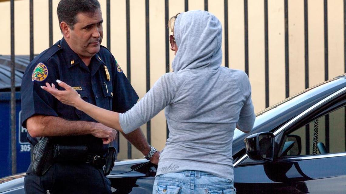 City of Miami Police Commander Jose Alfonso stops a suspected prostitute along Southwest Eighth Street in Miami during the morning rush hour on Wednesday, July 15, 2015, so he could check for outstanding warrants and offer her an opportunity to say if she is being coerced or abused. Her record came up clean and she left. Until recently Jose Alfonso was assigned to Miami-Dade State Attorney Katherine Fernandez Rundle's human trafficking unit. He won a national award in January for his work.