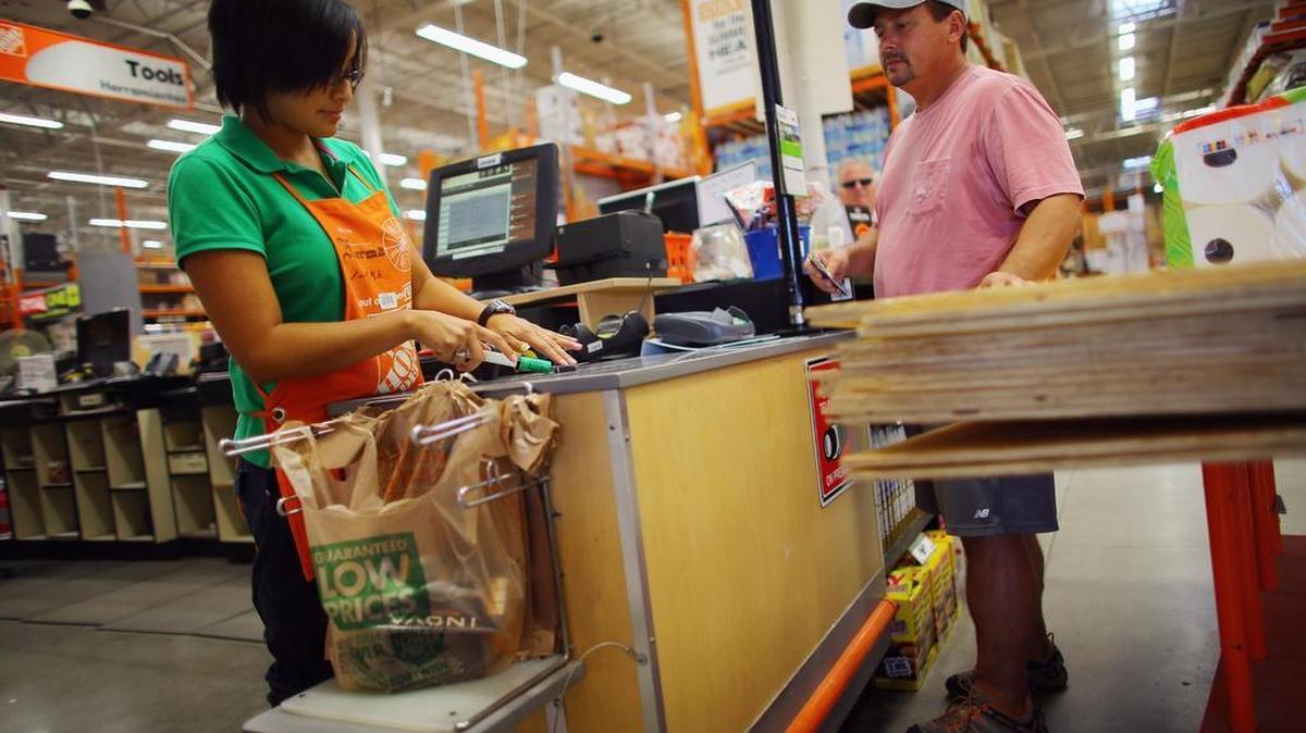 Norma Riverol rings up the hurricane supplies that Leonard Kaul is buying at Home Depot on August 24, 2012 in Seminole, Florida.