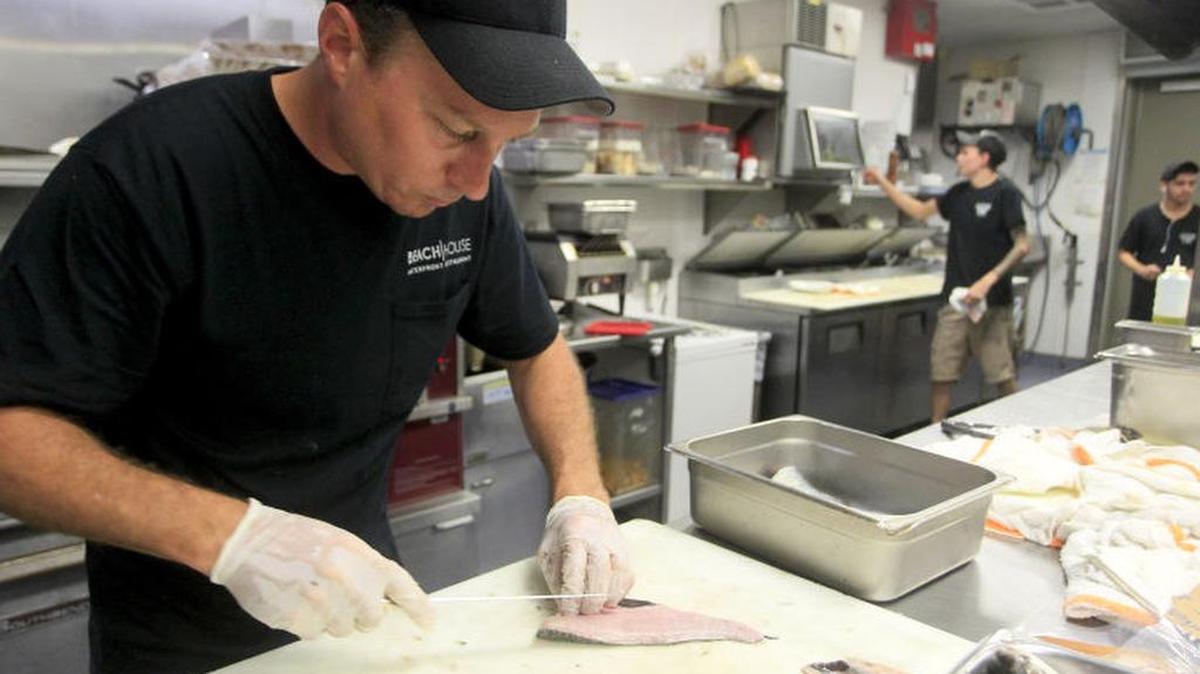 
Erik Walker, the research and development chef at the Anna Maria Island Sandbar Restaurant, fillets mullet caught locally. The restaurant’s owner, Ed Chiles, is part of a group developing a plan to eliminate mullet waste and popularize it as a food. 

