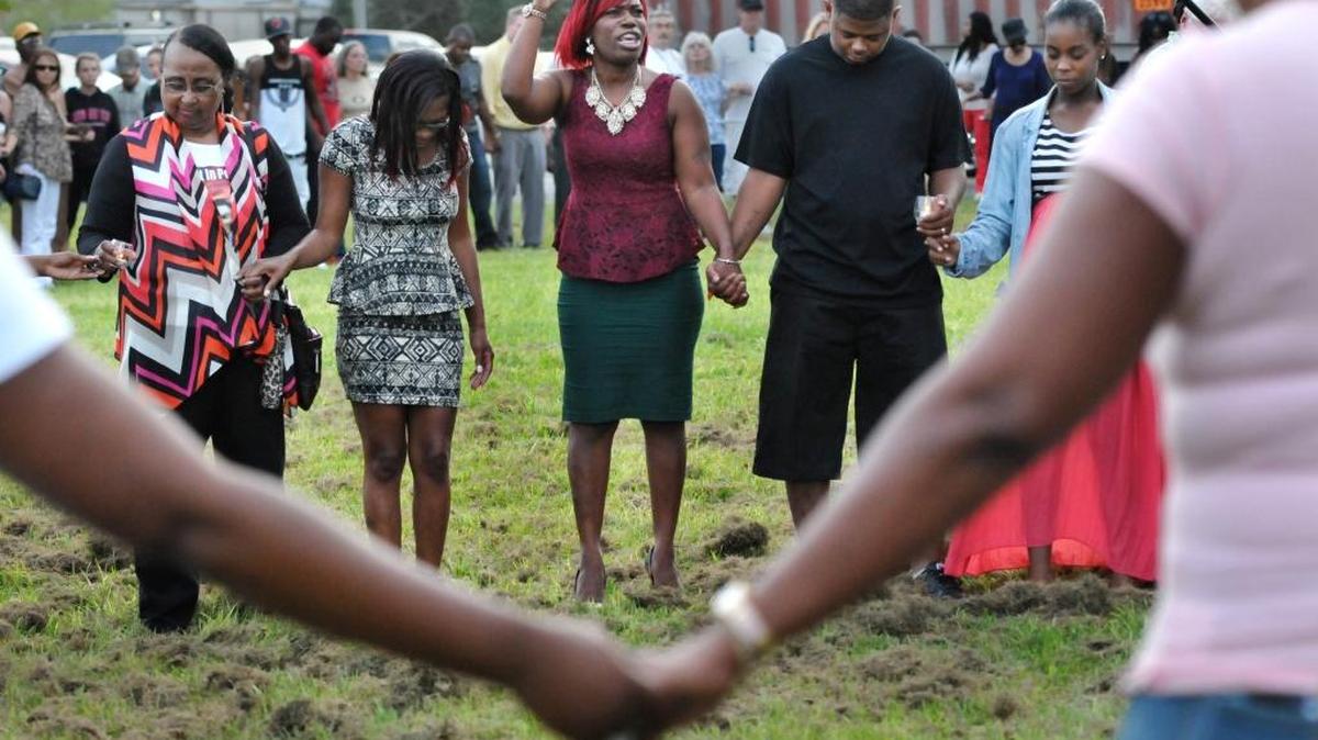 
Evangelist Barbara Ward, center, speaks during a candlelight vigil for the sunken cargo ship El Faro, Thursday, Oct. 8, 2015, in Jacksonville. U.S. safety investigators say the U.S. Navy soon will set out to find El Faro, sunk in Hurricane Joaquin.
