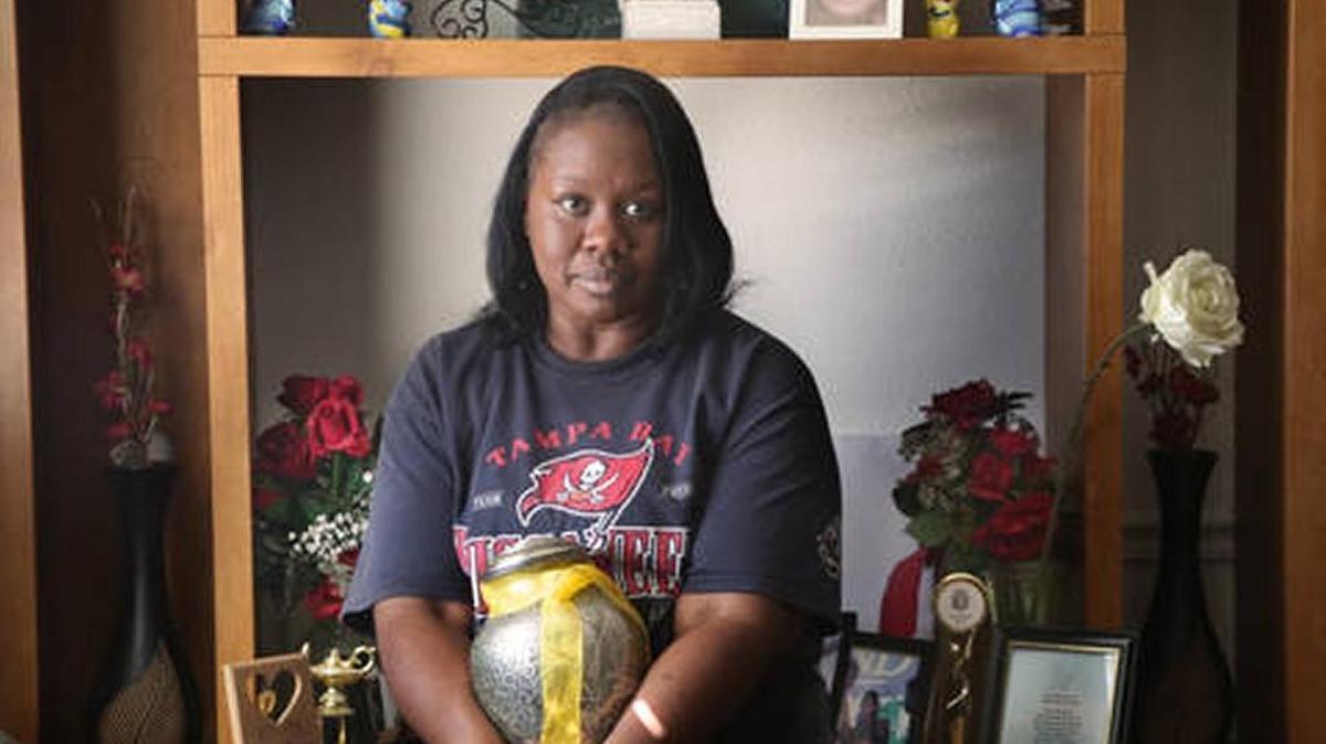 Patricia Davis, mother of Ikeim Boswell, holds his ashes near a shine to her son in her Tampa home Friday, February 10, 2017. Boswell was 16 when he was fatally shot March 14, 2015.