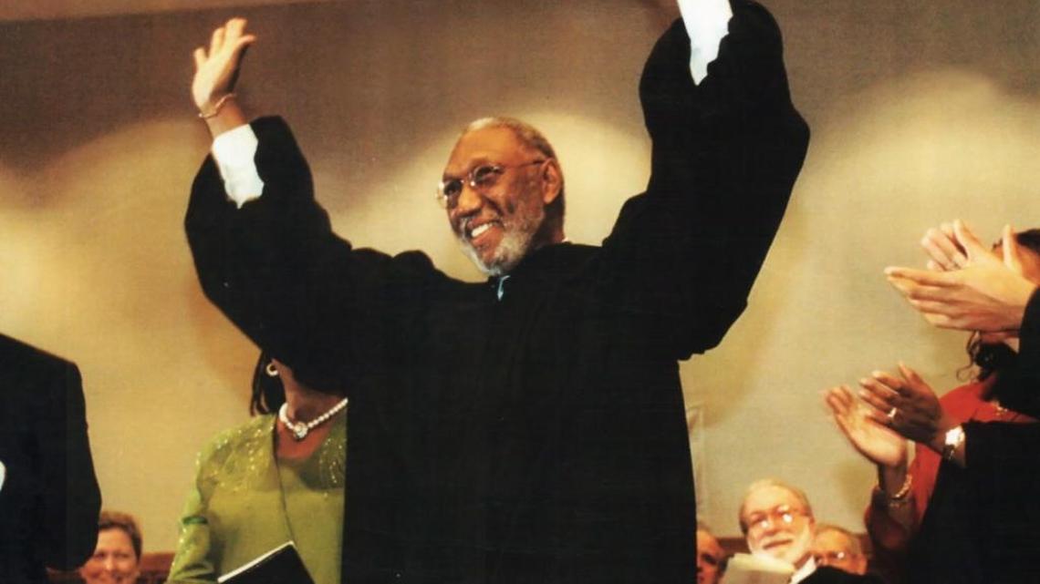 James Perry raises his arms in joy after being sworn in as the first black judge in the 18th Judicial Circuit and the first black judge in Seminole County. He was appointed to the bench in 2000 by former Gov. Jeb Bush.