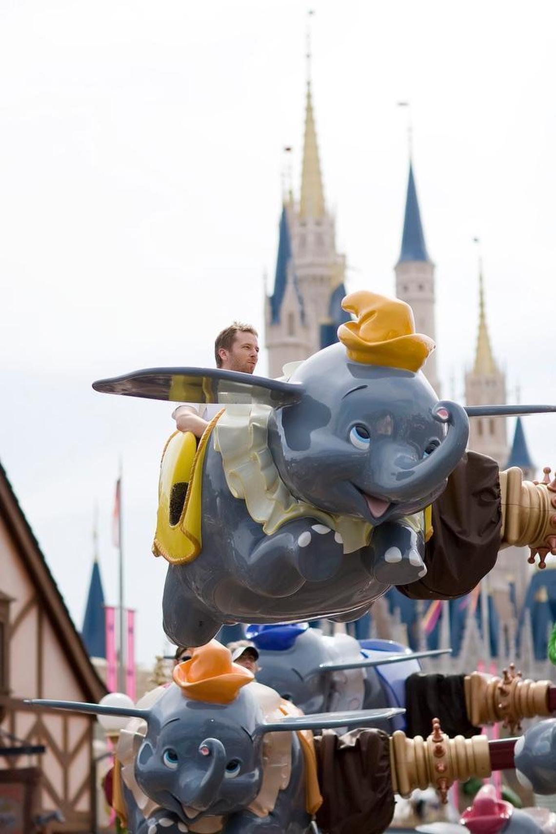 Guests ride on the Dumbo the Elephant attraction at the Walt Disney World Magic Kingdom in Orlando, Florida, U.S., on Wednesday, March 5, 2008.