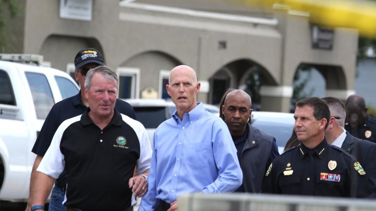 Florida Gov. Rick Scott arrives on the scene near the nightclub where a mass shooting occurred in Orlando, Fla., Sunday, June 12, 2016.