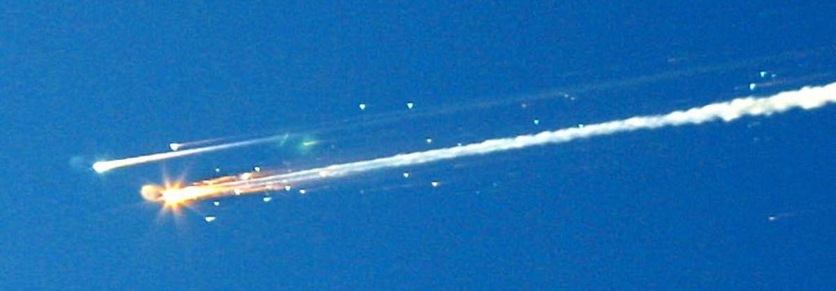 Debris from the space shuttle Columbia streaks across the sky over Tyler, Texas, on Saturday, Feb. 1, 2003. Amateur photographer Dr. Scott Lieberman shot a series of photos showing the break-up of the space shuttle from his backyard in Tyler. Space shuttle Columbia broke apart in flames 200,000 feet over Texas, killing all seven astronauts just minutes before they were to glide to a landing in Florida.