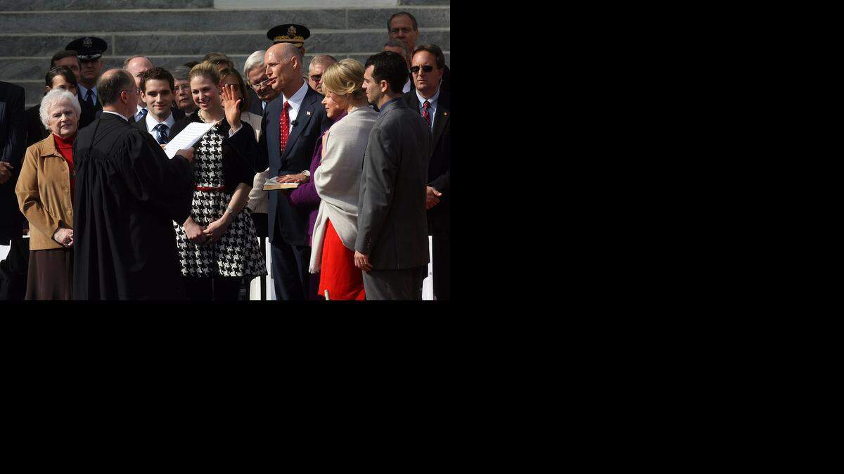
FIRST TIME: Gov. Rick Scott is sworn in for his first term of office in January of 2011. He will take the oath for his second term on Tuesday.
