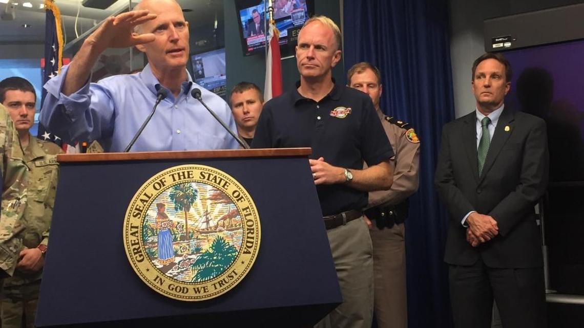 Bryan Koon, right, stands by while Gov. Rick Scott speaks during a briefing about Tropical Storm Emily on July 31, 2017, at the Emergency Operations Center in Tallahassee.