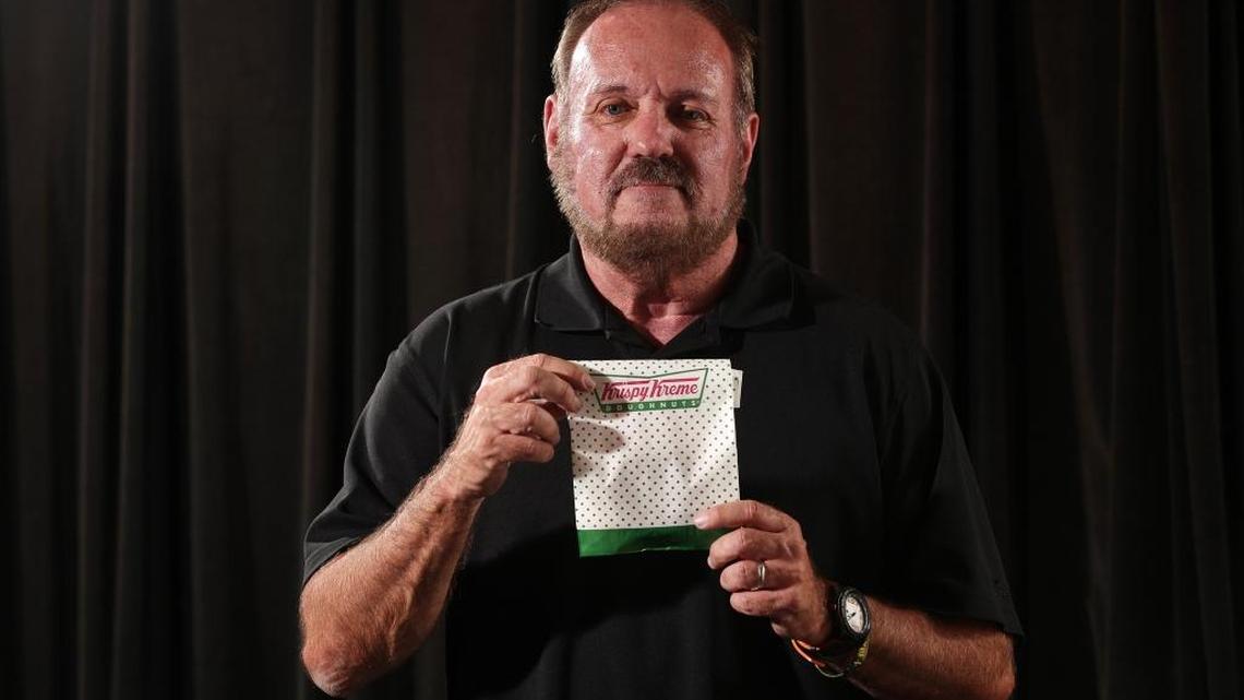 Daniel Rushing poses with the Krispy Kreme donut he purchases every other Wednesday on Wednesday, July 27, 2016 in Orlando, Fla.