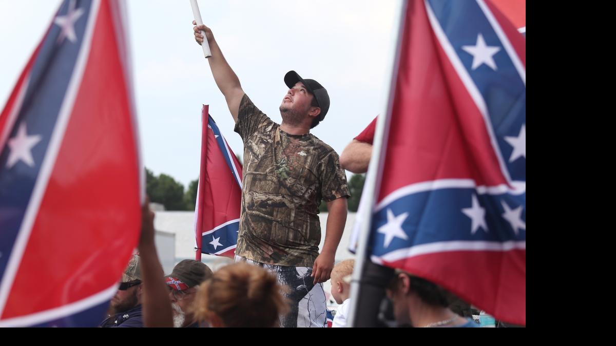 
Justin Carden waves a flag during a Confederate flag rally in Panama City Beach, Sunday, July 19, 2015. The 850 Confederacy hosted the Confederate Heritage Ride, Sunday according to the News Herald. 
