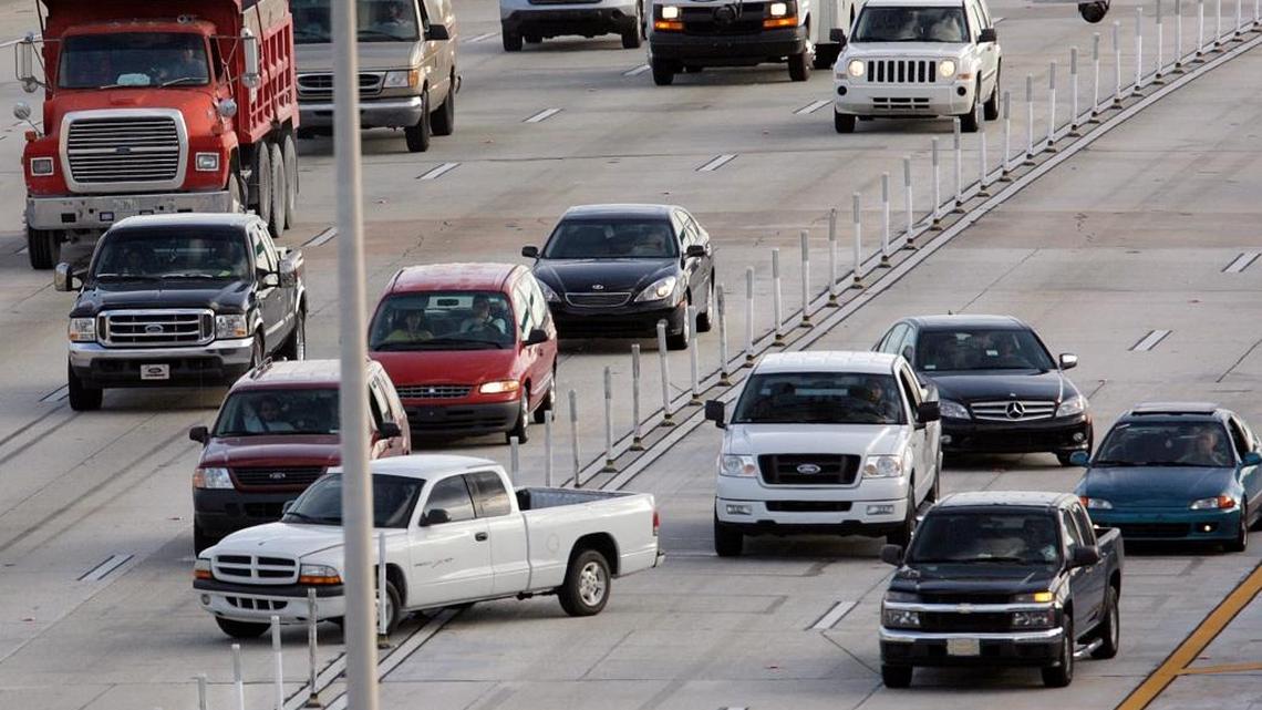 In this file photo, a pickup truck illegally crosses the barricades separating the two I-95 Express lanes, right, from normal traffic