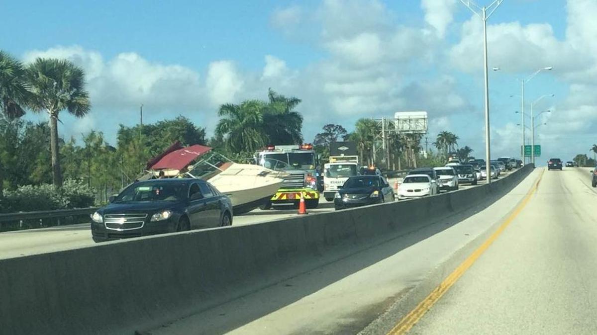 A boat blocks lanes on the Palmetto Expressway on Sunday morning.