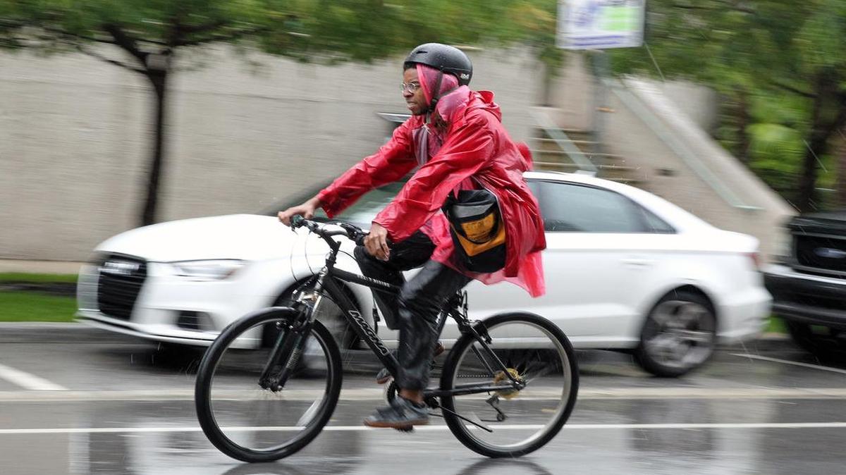 A cyclist rides his bike on a stormy Monday in Coconut Grove. The pattern of all-day rain will likely stick around for a few days, according to the National Weather Service. But there is potential that drier air coming from the Bahamas will have Tuesday looking a bit better. The rain chance in Miami is 30 percent and 20 percent in Broward.