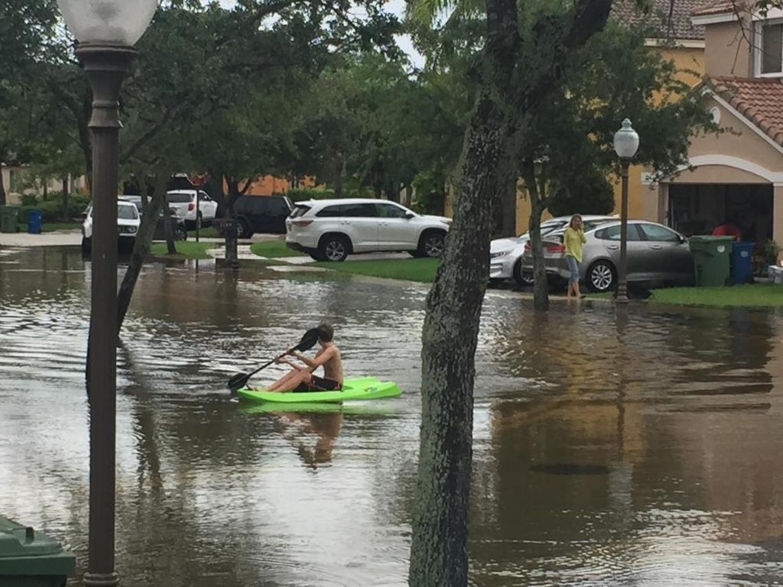 Water in the streets of the Savanna community in Weston was up to 18 inches, prompting at least one person to venture out in a kayak to navigate the road.