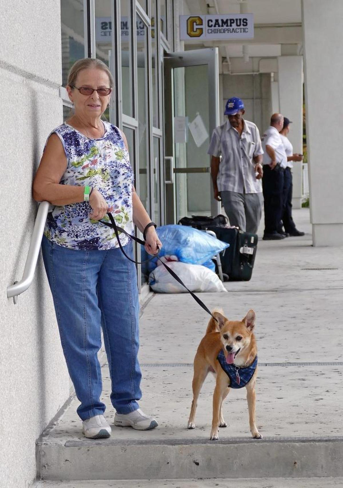 Mickie McElwee walks her dog, Josie, at an FIU shelter on Wednesday, September 13, 2017