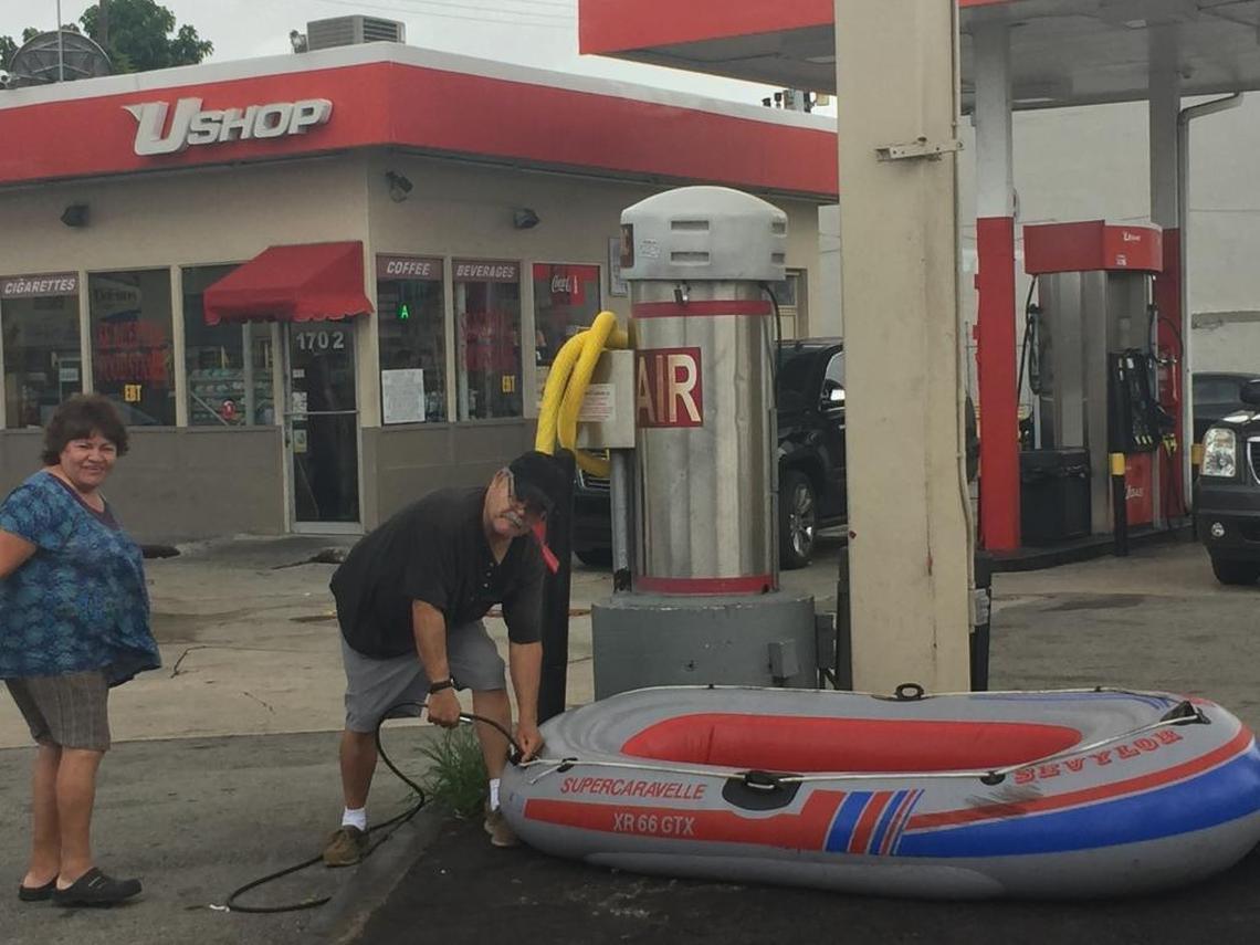 Lionel Perret plugs an air hose into his grey, 4-person Sevylor Supercaravelle raft.