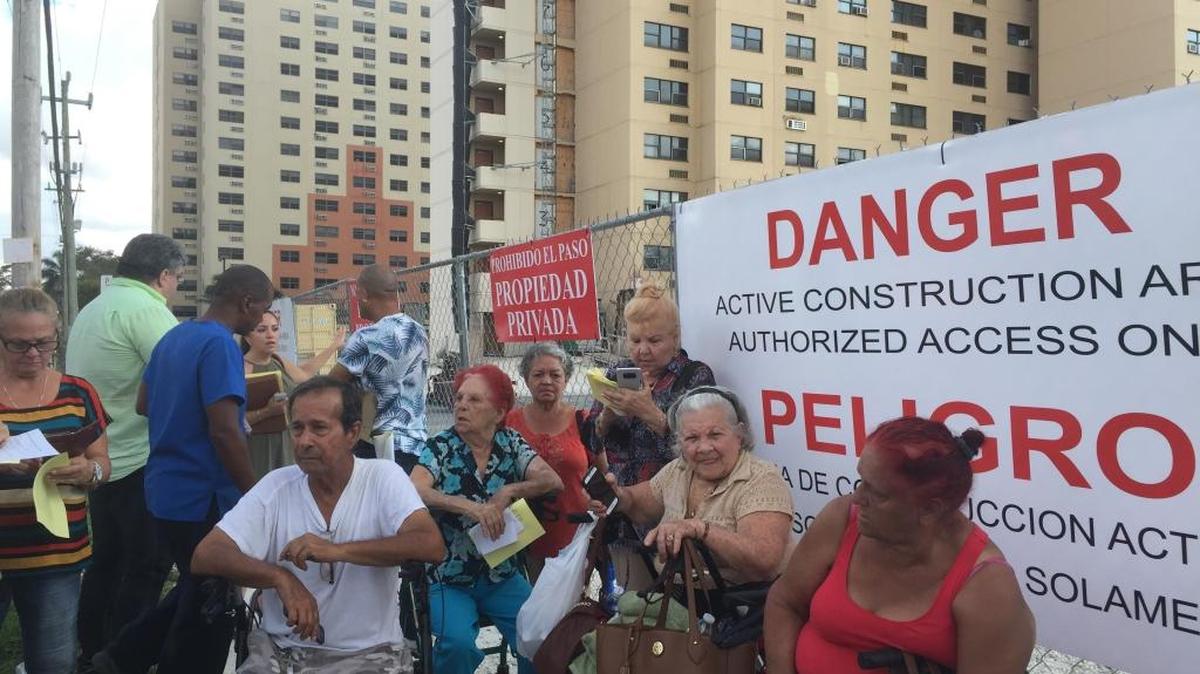 A group of Civic Towers residents protest outside.