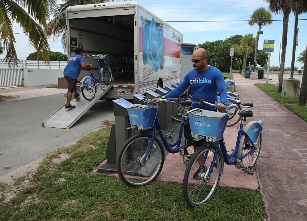 Citi bike employees Johnny Gonzalez (front ) and Elvis Castello, remove bikes from all stations in North Miami Beach as the city prepares for the possible arrival of Hurricane Irma in Miami Beach on September 06, 2017.