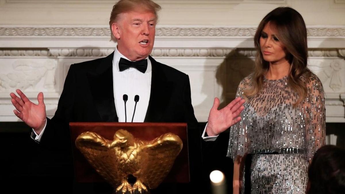 President Donald Trump with first lady Melania Trump, speaks during the White House Historical Association reception and dinner in the State Dining Room of the White House in Washington on Thursday.