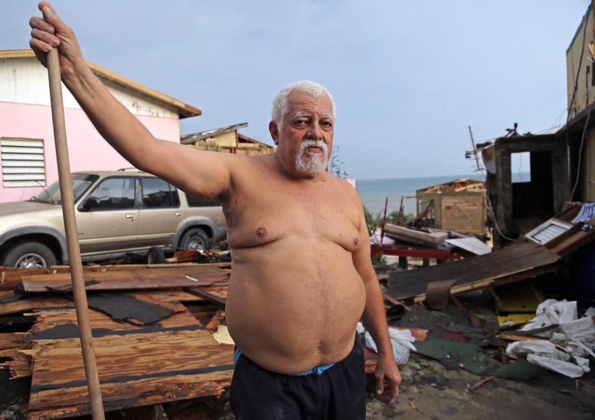 Luis Torres, take a break from sweeping his mother’s trashed home in the San Juan neighborhood of La Perla. Hurricane Maria blew away the house’s second floor.