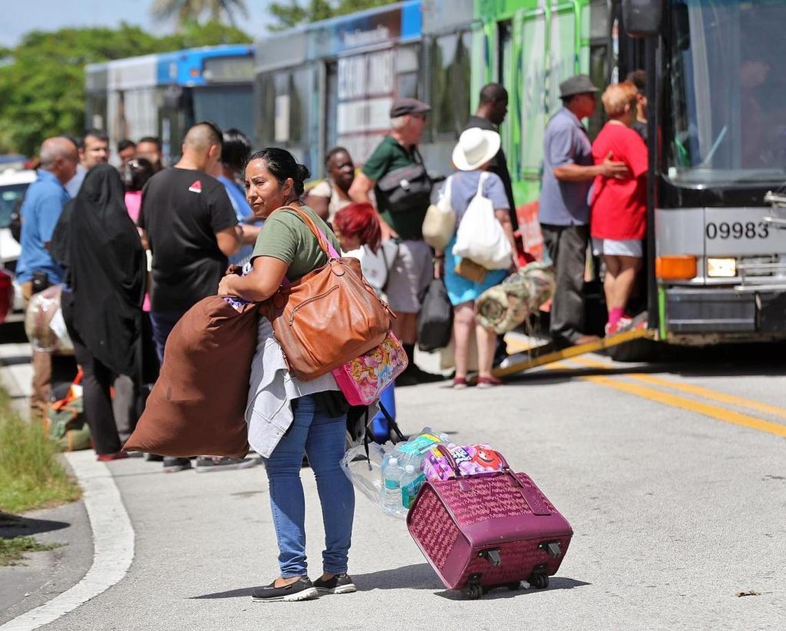 Hurricane Irma evacuees board a bus to go to another shelter as Robert Morgan Educational Center was filled to capacity of 2,400 people on Friday, September 8, 2017