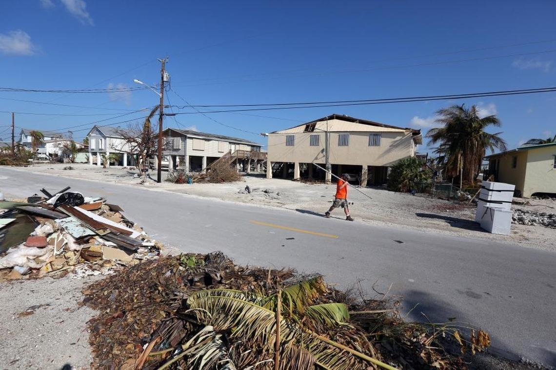David Byers, a hydrologic technician with the U.S. Geological Survey, walks along Constitution Avenue in Big Pine where he and team member Don Hampton found a high water mark hidden in the downstairs utility room of a house. The team is racing to document the marks and record storm surge levels before they are washed away in cleanup efforts.
