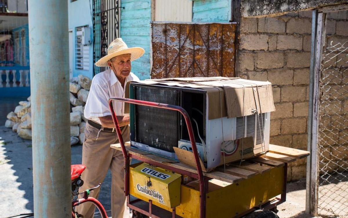 A man prepares to move an air conditioner to a secure place ahead of Hurricane Irma in Caibarien, Cuba.